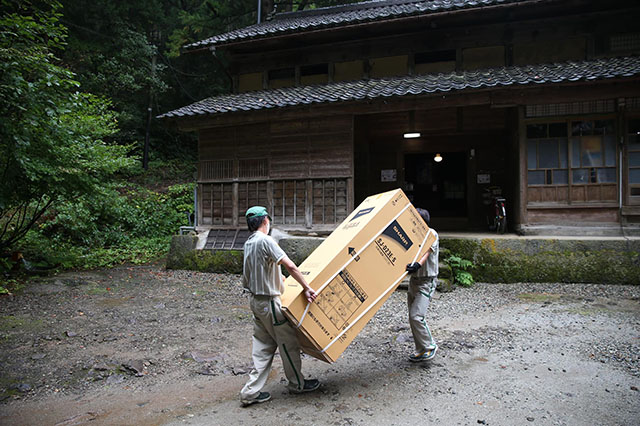 お庭から冷蔵庫を運んでいる